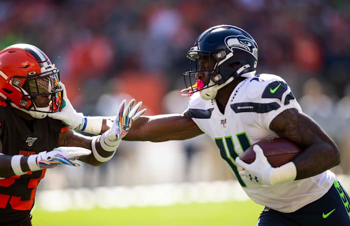 Seattle Seahawks wide receiver D.K. Metcalf (14) stiff arms Cleveland Browns strong safety Damarious Randall (23) during the first quarter at FirstEnergy Stadium.
